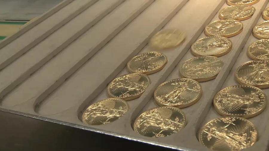 American Gold Eagle coins at the mint — rows of freshly struck Gold Eagles, the coins LBC Pawn buys in Boston