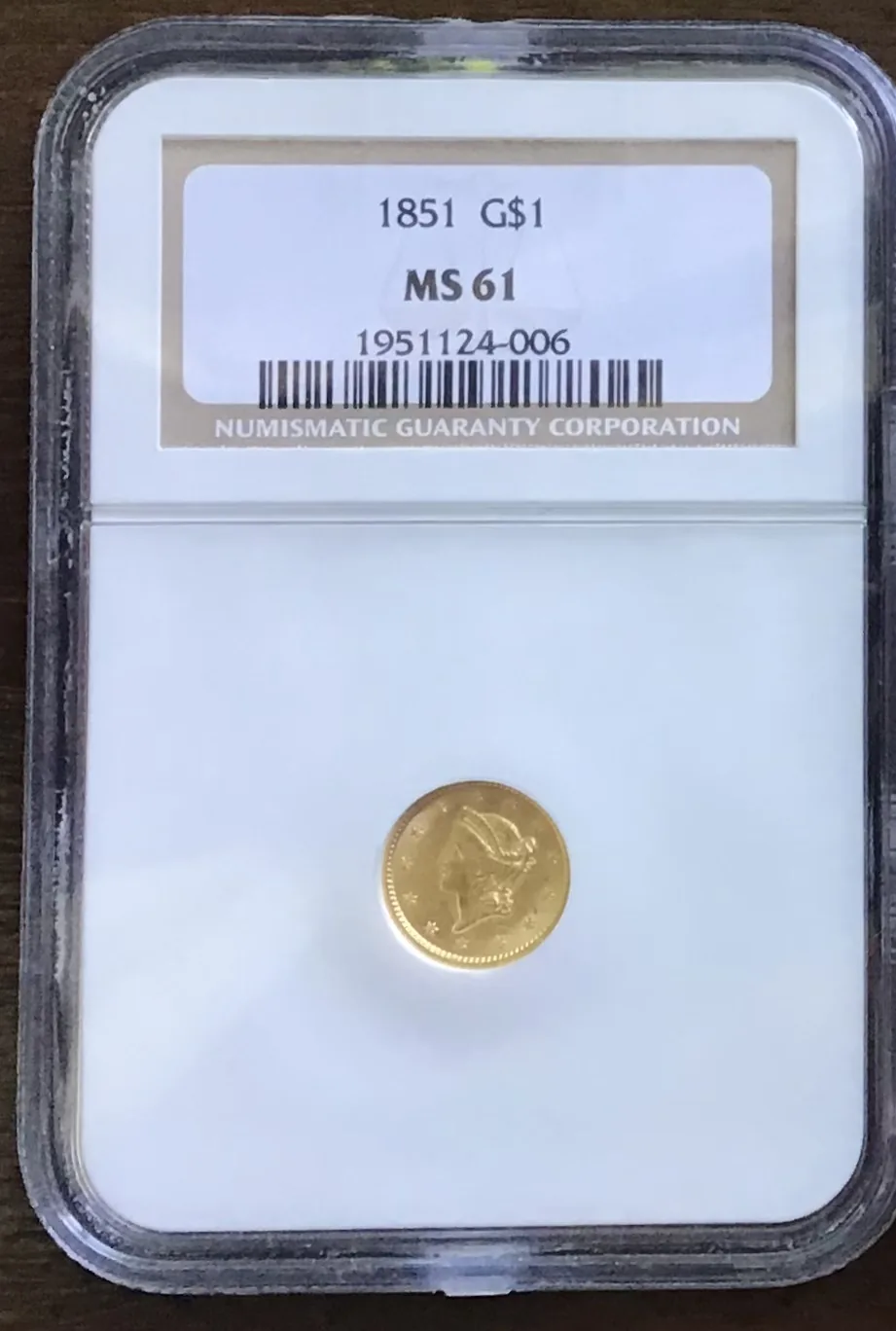 Graded gold coin in an NGC slab — an 1851 gold dollar certified MS 61, bought in Boston at LBC Pawn