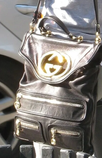 Gucci black leather shoulder bag with gold interlocking GG logo — we buy Gucci in Boston