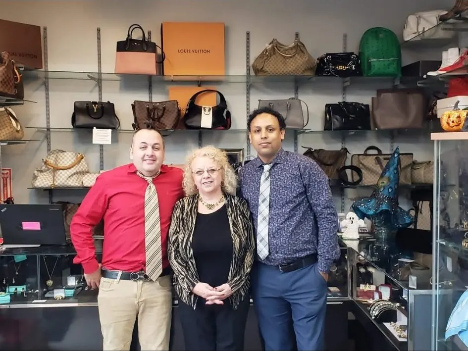 Designer bags in Boston — the designer handbag wall at LBC Pawn, with the LBC family team