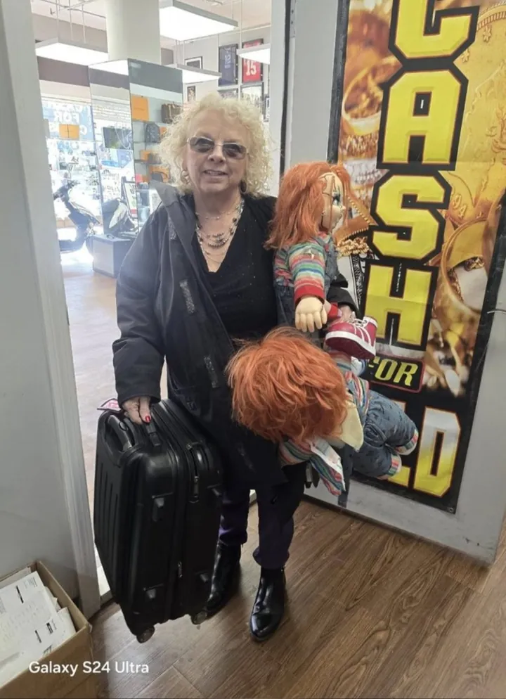 Denise at LBC Pawn with a Chucky doll from the collectibles shelf